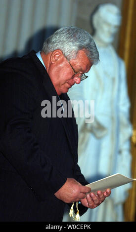 Speaker of the House Dennis Hastert looks through the program with the statue of Abraham Lincoln in the background during a ceremony to award civil rights activists  the Congressional Gold Medal on September 8, 2004, in Washington. The awardees received the award for their participation in the Briggs v. Elliott court case which was one of five cases collectively known as Brown v. Board of Education.  (UPI Photo/Michael Kleinfeld) Stock Photo