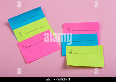 Plan of the week on colored blank stickers on pink background Stock Photo