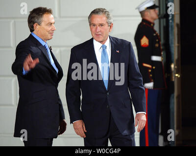 British Prime Minister Tony Blair waves to the press as U.S. President George W. Bush looks on after Blair arrived at the South Portico of the White House on Nov. 11, 2004. Blair and Bush will have dinner tonight and hold a meeting on Nov. 12.   (UPI Photo/Roger L. Wollenberg) Stock Photo