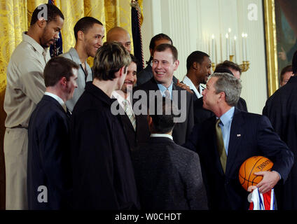 President George W. Bush shakes hands with members of the Detroit Pistons after a ceremony for the NBA 2004 Champs in the East Room of the White House on January 31, 2005. (UPI Photo/Michael Kleinfeld)