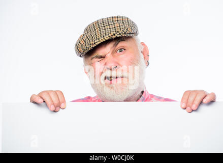 Senior bearded emotional man peek out of banner place announcement. Elderly person. Announcement concept. Event announcement. Pensioner grandfather in vintage hat poster information copy space. Stock Photo