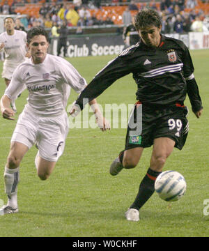 D.C. United forward Jaime Moreno (99) drives past New England Revolution defender Jay Heaps (6) during their MLS match up on April 23, 2005 at RFK Stadium in Washington, D.C. The Revolution beat the United 4-3. (UPI Photo/Kevin Dietsch) Stock Photo