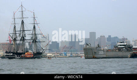 The USS Constitution, Boston's beloved 'Old Iron Sides', is escorted by multiple Coast Guard resources out to Ft. Independence at Island Castle Hill in south Boston where the USS Contitution fired its 21-gun salute, and was then brought back to her dock in Charlestown Navy Yard on June 11, 2005.  (UPI Photo/Kelly Newlin/Coast Guard) Stock Photo