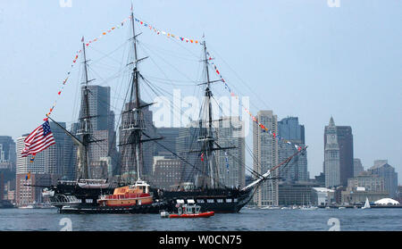 The USS Constitution, Boston's beloved 'Old Iron Sides', is escorted by multiple Coast Guard resources out to Ft. Independence at Island Castle Hill in south Boston where the USS Contitution fired its 21-gun salute, and was then brought back to her dock in Charlestown Navy Yard on June 11, 2005.  (UPI Photo/Kelly Newlin/Coast Guard) Stock Photo