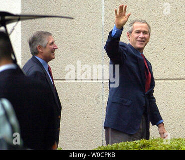 US President George W. Bush waves as he arrives with Chief of Staff Andrew Card at the National Naval Medical Center in Bethesda, Maryland for his annual physical examination, July 30, 2005.  Bush is also expected to visit US troops recuperating from combat wounds during his visit at the hospital.          (UPI Photo/Mike Theiler) Stock Photo