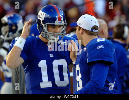 New York Giants quarterbacks Eli Manning and Kurt Warner celebrate on the  field after the game. The New York Giants defeated the Dallas Cowboys 28 to  24 at Giants Stadium in East