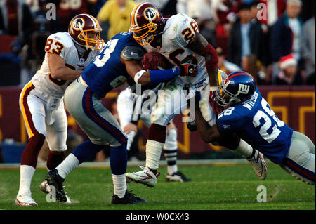 Washington Redskins Clinton Portis (26) breaks the tackle of New York Jets  Victor Hobson (54) in the first quarter at Giants Stadium in East  Rutherford, New Jersey on November 4, 2007. The