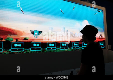 Jerusalem, Israel. 27th June 2019. Israeli boy playing with an interactive simulator in which visitors need to intercept rockets aimed at populated areas with Israeli anti missile device called Iron Dome at a special exhibition open to the public called ‘Our IDF’ being jointly run by the Israeli army and the Ministry of Defense, in which visitors take part in various interactive activities and experience the strength of the army. Credit: Eddie Gerald/Alamy Live News Stock Photo