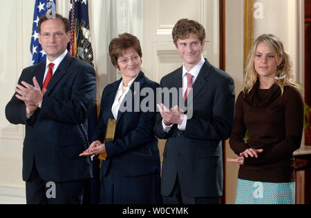 Newly appointed Supreme Court Justice Samuel Alito (L) applauds alongside his wife Martha-Ann, son Phil and daughter Laura after being sworn in as Justice of the Supreme Court at the White House, in Washington on February 1, 2006. (UPI Photo/Kevin Dietsch) Stock Photo