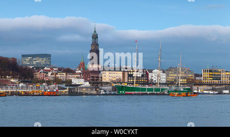 Panoramic cityscape of Hamburg with modern and old buildings on Elbe river coast at evening Stock Photo