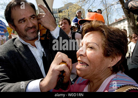 Alicia Mandozza, 70, who is originally from El Salvador and traveled from San Francisco to support to the protest, chants, 'We are America' as Rafael Alfaro with the Carecen Group lends her his bullhorn during a rally in Washington on April 10, 2006.  Tens of thousands of immigrants and their supporters rallied  against a House bill that would criminalize illegal immigrants and for reform measures that would protect their rights.  (UPI Photo/Chris Rossi) Stock Photo