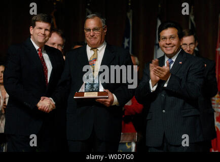 Attorney General Alberto Gonzales (L) claps as Deputy Attorney General Paul McNulty shakes hands with David Margolis  after awarding him with The Mary C. Lawton Lifetime Service Award, during The Attorney General's 54th Annual Awards Ceremony, in Washington on September 12, 2006. The awards ceremony honors justice and law enforcement employees from around the country that have show extraordinary service to their field or department. (UPI Photo/Kevin Dietsch) Stock Photo