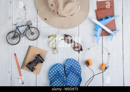 Prepare for journey - accessories and travel items, packing clothes: hat, passport, tickets, model of airplane and bicycle, flip flops, sunglasses, co Stock Photo