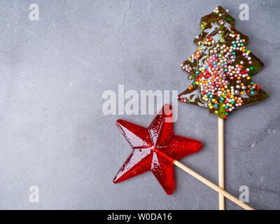 Two candy lollipop in the form of star, christmas tree on concrete background Stock Photo