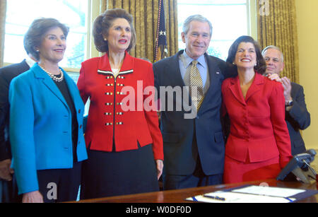 U.S. President George W. Bush and First Lady Laura Bush greet Lynda Bird Johnson Robb (LC) and Luci Baines Johnson (R), President Johnson's daughters, after signing H.R. 584, the Lyndon Baines Johnson Department of Education Building bill, in the Oval Office of The White House on March 23, 2007.    (UPI Photo/Roger L. Wollenberg) Stock Photo