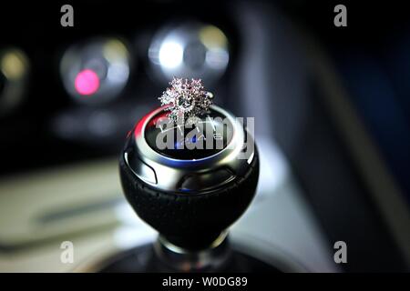 Jewelry Ring on top of car gear stick. Stock Photo