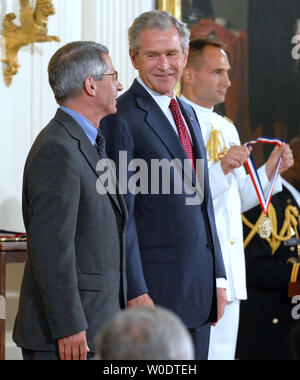 U.S. President George W. Bush prepares to present National Institute of Allergy and Infectious Diseases Director Dr. Anthony Fauci (L) with his award during a ceremony honoring the 2005 and 2006 National Medals of Science and Technology in the East Room of the White House on July 27, 2007.     (UPI Photo/Roger L. Wollenberg) Stock Photo