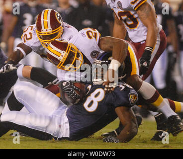 Washington Redskins Sean Taylor (21) and Rock Cartright (31) tie up St.  Louis Rams David Allen on a punt return in the first quarter at the Edward  Jones Dome in St. Louis