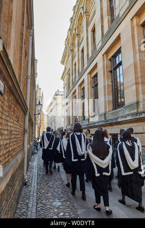 Celebration day at the university of Cambridge, England, as graduand students (from Trinity Hall college) in their academic gowns process in an orderly queue along Senate House passage to enter Senate House on 27th June 2019 for their graduation ceremony. Stock Photo