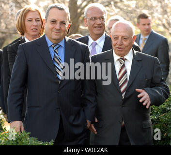Israeli Minister of Defense Ehud Barak (left front), Palestinian chief negotiator Ahmed Qurei (right front) followed by Israeli Foreign Minister Tzipi Livni (L), and Palestinian Prime Minister Salam Fayyad (center) and other officials arrive to watch as (not pictured) U.S. President George W. Bush, Palestinian President Mahmoud Abbas and Israeli Prime Minister Ehud Olmert appear before the media in the Rose Garden of the White House after their meeting in the Oval Office on November 28, 2007.    (UPI Photo/Roger L. Wollenberg) Stock Photo