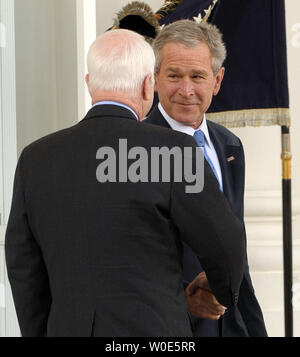 U.S. President George W. Bush (R) greets Republican presumptive presidential nominee Sen. John McCain (R-AZ) on the North Portico of the White House on March 5, 2008. Republican presidential candidate Mike Huckabee conceded the race last night after it was clear McCain would win the Texas and other primaries.   (UPI Photo/Roger L. Wollenberg) Stock Photo