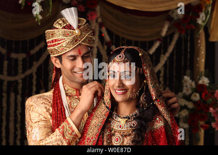 Indian bridegroom putting Mangalsutra 