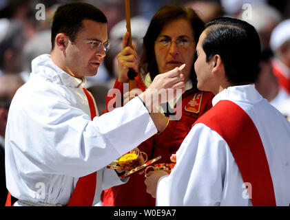 Members of the Roman Catholic clergy participate in communion during Pope Benedict XVI's mass at Nationals Park in Washington on April 17, 2008. Approximately 50,000 people are expected in attendance for the Pope's mass. (UPI Photo/Kevin Dietsch) Stock Photo