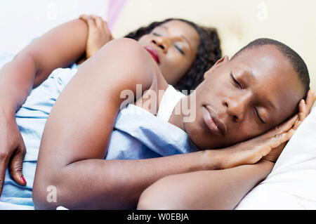 tired beautiful young loving couples sleep deeply together in their bed. Stock Photo