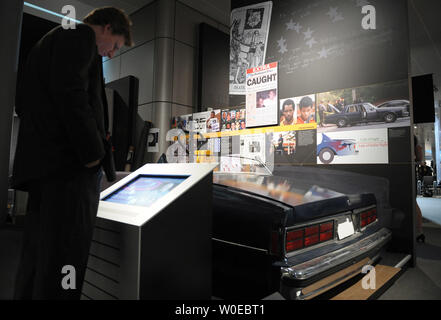 A man looks at an exhibit about the Beltway Snipers during a preview of the Newseum's new exhibit, 'G-Men and Journalists: Top News Stories of the FBI's First Century' in Washington, on June 17, 2008. The Chevy Caprice seen in this photo, used as a demonstration piece in court, is a duplicate of the one used by the snipers. The exhibit, which opens June 20, corresponds with the FBI's 100th anniversary.   (UPI Photo/Roger L. Wollenberg) Stock Photo