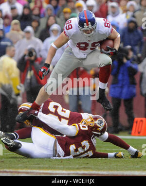 Washington Redskins LaRon Landry (30) puts down San Francisco 49ers Josh  Morgan on his head after he caught a Shaun Hill Pass in the third quarter  at Candlestick Park in San Francisco