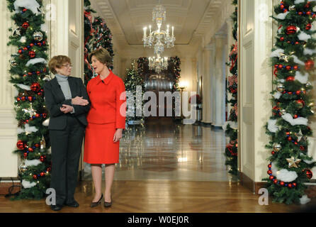 First lady Laura Bush (R) talks with Chief Florist Nancy Clarke as she delivers remarks during the 2008 White House Christmas decoration presentation in the White House in Washington on December 3, 2008. The theme for this year's holiday decorations in 'A Red, White And Blue Christmas.' (UPI Photo/Kevin Dietsch) Stock Photo