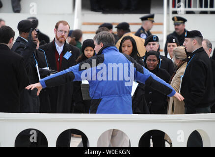 A Presidential Inauguration producer measures the distance between a stand-in for President-elect Barack Obama (L) as he takes the oath of office from Supreme Court Chief Justice John Roberts (R) during a dress rehearsal of the Presidential Inauguration ceremony at the U.S. Capitol on January 11, 2009. Other stand-ins wear signs over their necks.  Obama will take the oath of office and become the 44th president of the United States on January 20, 2009.  Millions are expected in Washington for the event.  (UPI Photo/Pat Benic) Stock Photo