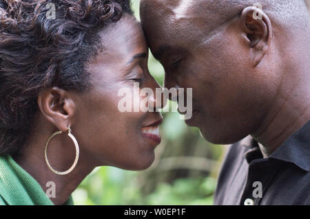 closeup of a romantic couple standing face to face and embracing in campaign. Stock Photo