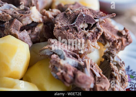 Boiled lamb meat and whole potatoes close up Stock Photo