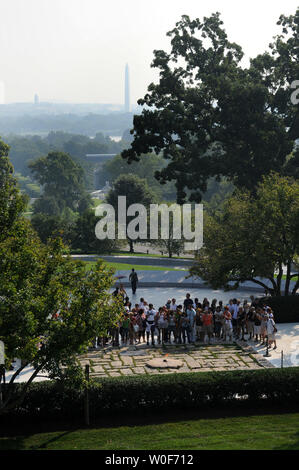 Visitors pass by the burial site of President John F. Kennedy and his family at Arlington National Cemetery in Arlington, Virginia on August 27, 2009.  Senator Kennedy who passed away late Tuesday night at the age of 77, will be buried near his brother in Arlington.      UPI/Kevin Dietsch Stock Photo