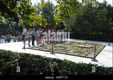 Visitors pass by the burial site of President John F. Kennedy and his family at Arlington National Cemetery in Arlington, Virginia on August 27, 2009.  Senator Kennedy who passed away late Tuesday night at the age of 77, will be buried near his brother in Arlington.      UPI/Kevin Dietsch Stock Photo