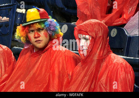 Baseball fans wearing ponchos wait during a rain delay prior to game 3 of the World Series between the New York Yankees and Philadelphia Phillies in Philadelphia on October 31 2009. UPI Kevin Dietsch ...