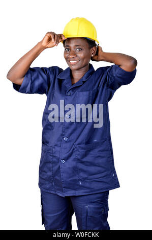 Construction worker wearing her helmet and smiling on a white background. Stock Photo