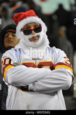 A Washington Redskins' fan wearing a Santa Clause beard and hat watches as  the Redskins play the New York Giants' at FedEx Field in Landover, Maryland  on December 21, 2009. UPI/Kevin Dietsch