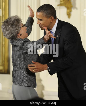 U.S. President Barack Obama hugs Rita Moreno before he awards her the 2009 National Arts Medal during a ceremony in the East Room of the White House in Washington on February 25, 2010. Moreno, a Puerto Rican singer, dancer and actress, is the first and only Hispanic and one of ten performers who have won an Emmy, a Grammy, an Oscar, and a Tony.   UPI/Mike Theiler Stock Photo