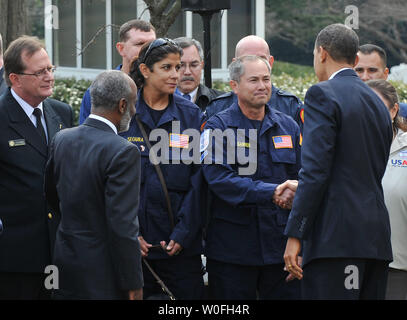 U.S. President Barack Obama (R) and Haitian President Rene Garcia Preval (L) greet members of USAID, who assisted in search and rescue missions in Haiti following the countries devastating earthquake, following a meeting in the Oval Office at the White House in Washington on March 10, 2010.  UPI/Kevin Dietsch Stock Photo