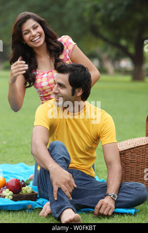 Indian couple having a picnic Stock Photo - Alamy