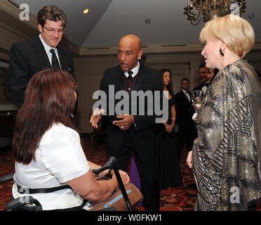 Montel Williams (2nd R) speaks with Tammy Duckworth (L), Assistant Secretary of Public Affairs for the Department of Veterans Affairs, Nathan Naylor, Assistant Secretary of Public Affairs, and  Elaine Rogers (R), president of USO of Metropolitan Washington, at the USO 28th Annual Awards Dinner in Arlington, Virginia on April 14, 2010. UPI/Alexis C. Glenn Stock Photo