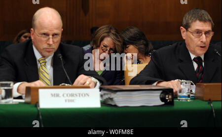 Federal Deposit Insurance Corporation (FDIC) Chair Sheila Bair (RC) speaks to an aide as John Corston, Acting Deputy Director, Large Institutions and Analysis Branch, FDIC (L) and George Doerr, Deputy Regional Director, Division of Supervision and Consumer Protection at the FDIC testify before a Senate Homeland Security and Governmental Affairs Investigations Subcommittee hearing on the role of bank regulators in the housing market crises on Capitol Hill in Washington on April 16, 2010.    UPI/Roger L. Wollenberg Stock Photo