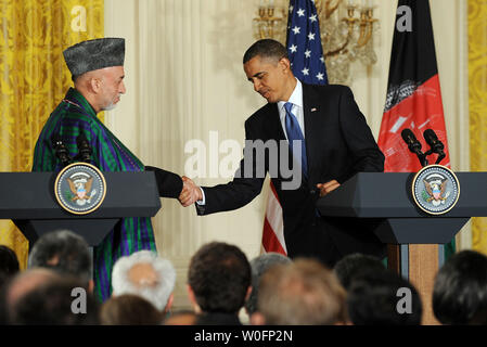 Afghan President Hamid Karzai shakes hands with U.S. President Barack Obama after they spoke to the media in the East Room of the White House following their meeting in Washington on May 12, 2010.    UPI/Roger L. Wollenberg Stock Photo