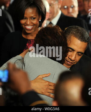 U.S. President Barack Obama hugs the mother of a fallen soldier after awarding Staff Sergeant Salvatore Giunta, U.S. Army, the Medal of Honor for conspicuous gallantry during a ceremony in the East Room of the White House in Washington on November 16, 2010. Giunta received the Medal for actions during combat in the Korengal Valley, Afghanistan in October 2007. At left is First Lady Michelle Obama.   UPI/Roger L. Wollenberg Stock Photo