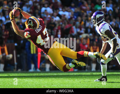 Chris Cooley of the Washington Redskins makes a fourth quarter reception  and touchdown against Kim Herring of the Cincinnati Bengals who defeated  the Redskins 17-10 on November 14, 2004 at Fed Ex