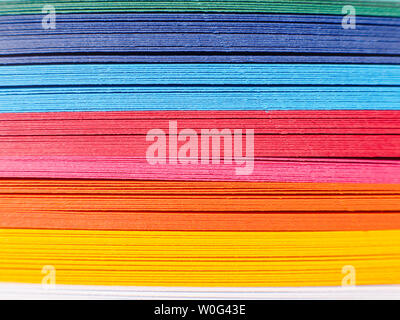 Colored paper, cross section. Paper strips in rainbow colors as a colorful backdrop. The colored paper on a background. Stock Photo