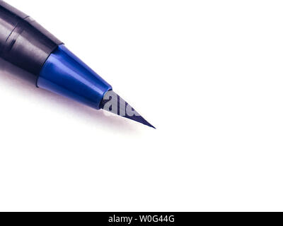 Black marker on a white background. Blue highlighter. Education painting concept. Copy space. Stock Photo