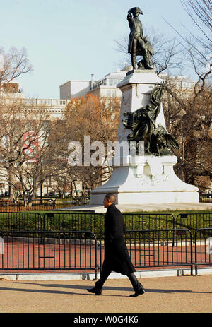 U.S. President Barack Obama walks from the White House across Pennsylvania Avenue to the Blair House to hold a working meeting with business leaders in Washington on December 15, 2010. Behind him is a statue of Lieutenant General Comte de Rochambeau in Lafayette Park.     UPI/Roger L. Wollenberg Stock Photo